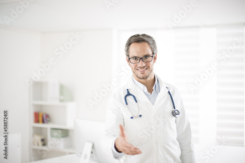young doctor welcoming at his office