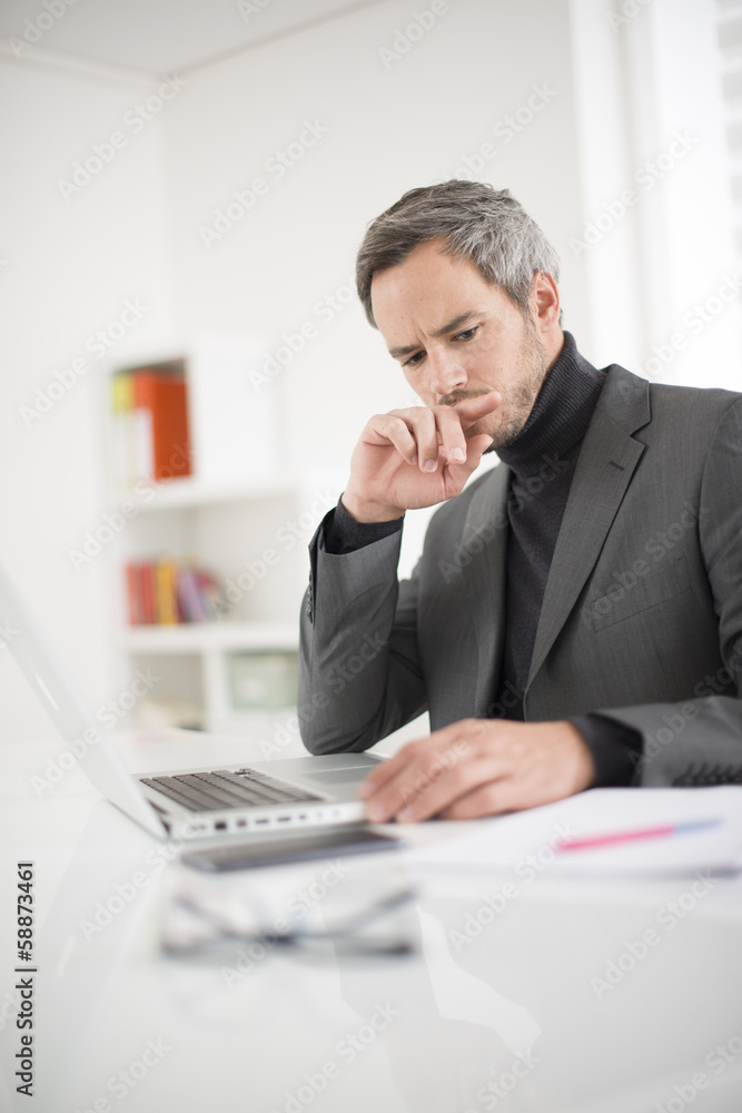 attractive man working in office attractive man working in office