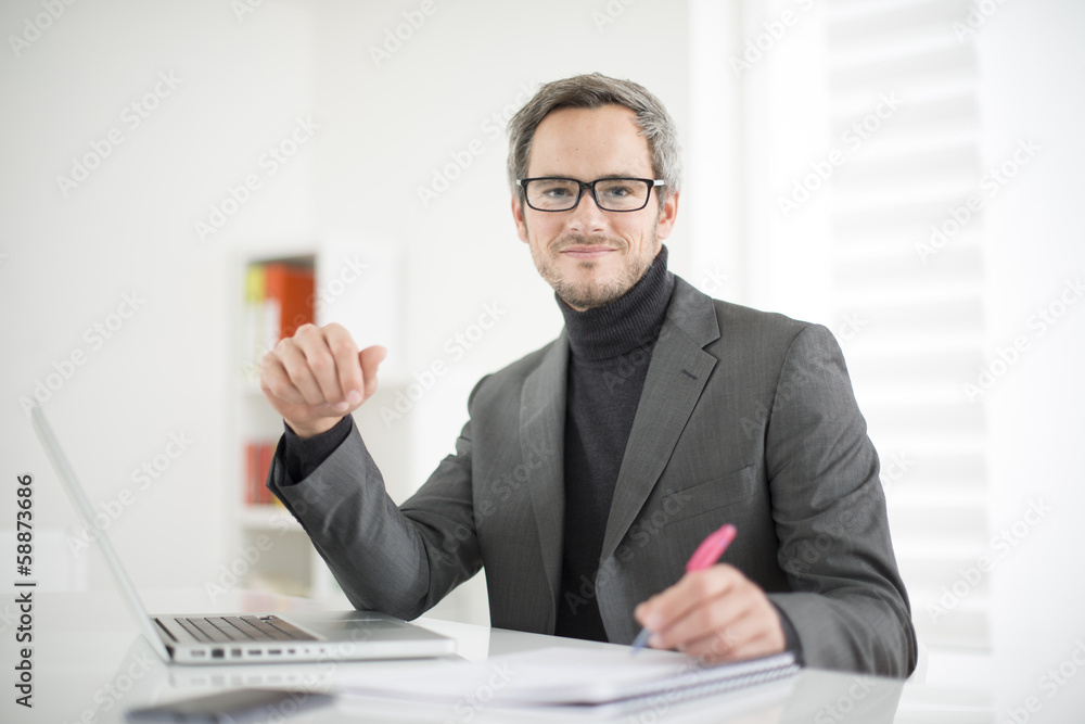 attractive man working in office attractive man working in office