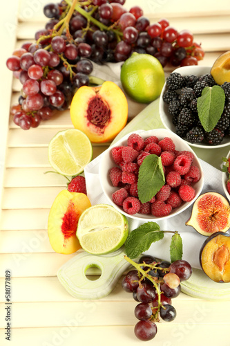 Fototapeta Naklejka Na Ścianę i Meble -  Assortment of juicy fruits and berries on wooden background
