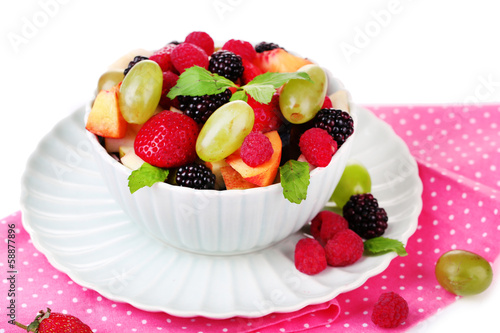 Fruit salad in bowl, isolated on white