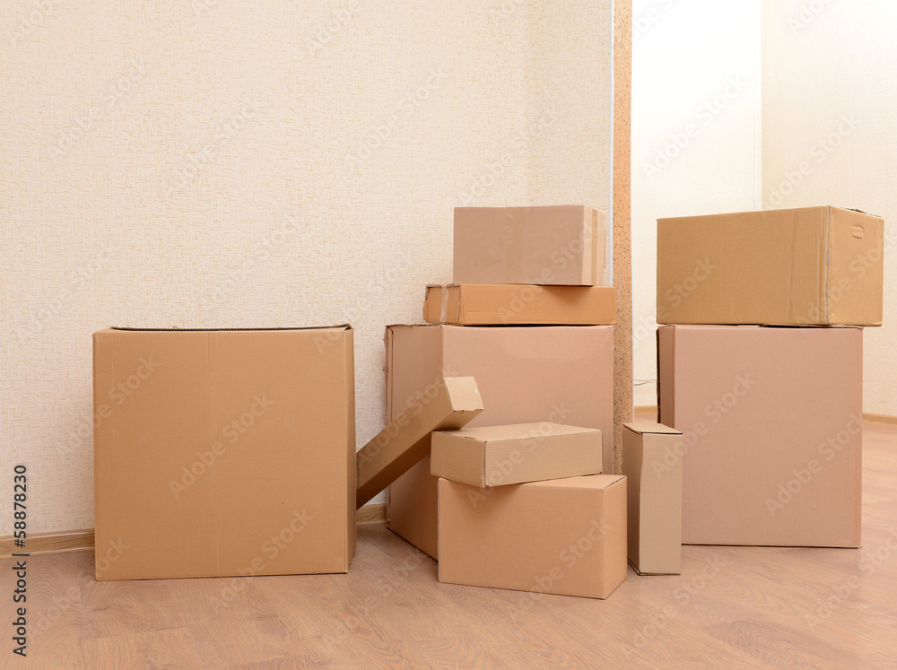 Empty room with stack of cartons: moving house concept Empty room with stack of cartons: moving house concept