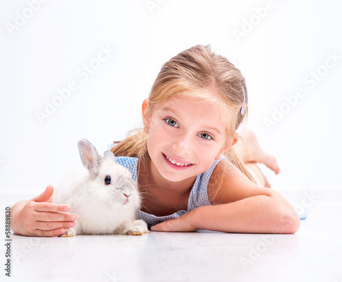 cute little girl a white rabbit © tan4ikk