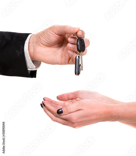 Male hand giving car key to female hand