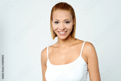 Pretty young woman smiling warmly © stockyimages