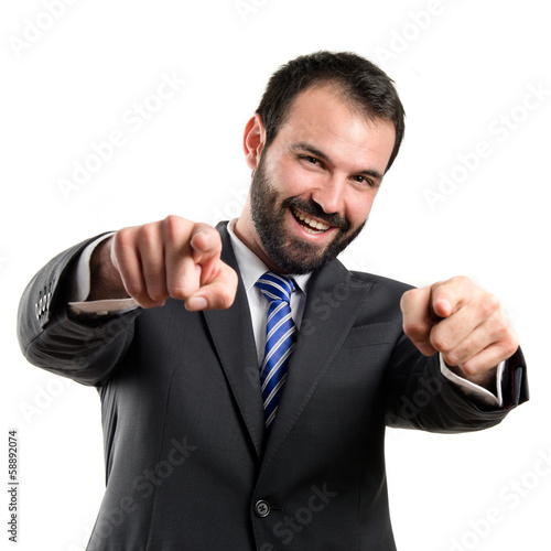 Businessman pointing to the front over white background