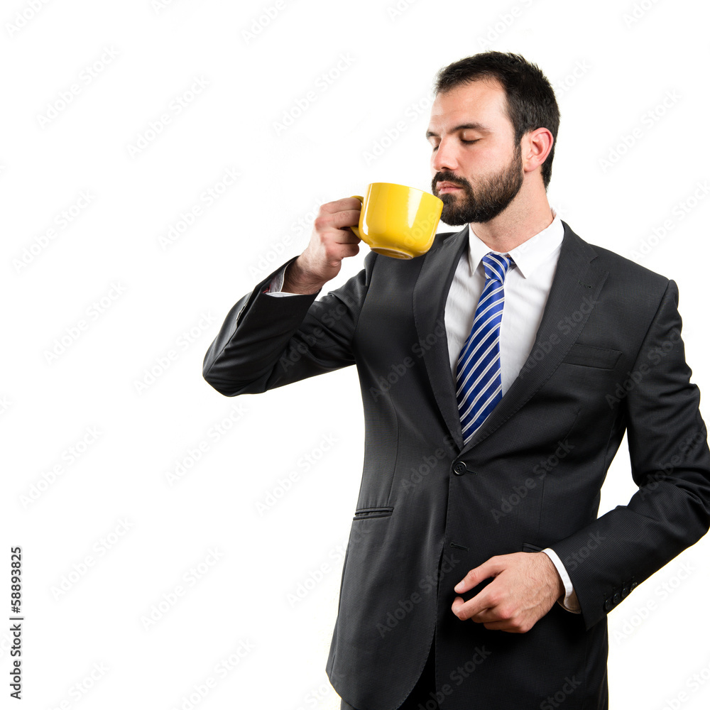 Young businessman drinking a coffee over white background Young businessman drinking a coffee over white background