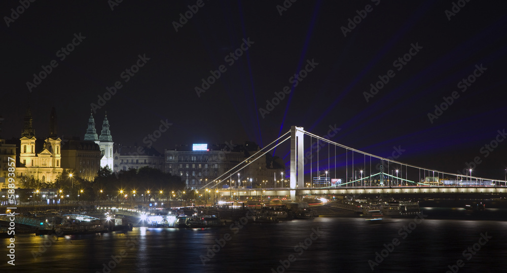 Elizabeth bridge with laser rays on the evening sky in Budapest,