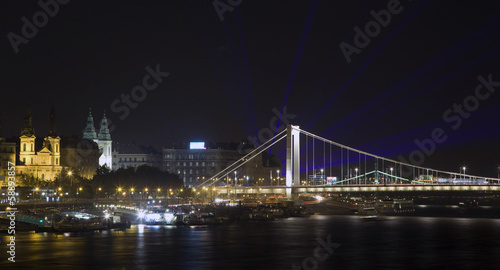 Elizabeth bridge with laser rays on the evening sky in Budapest 