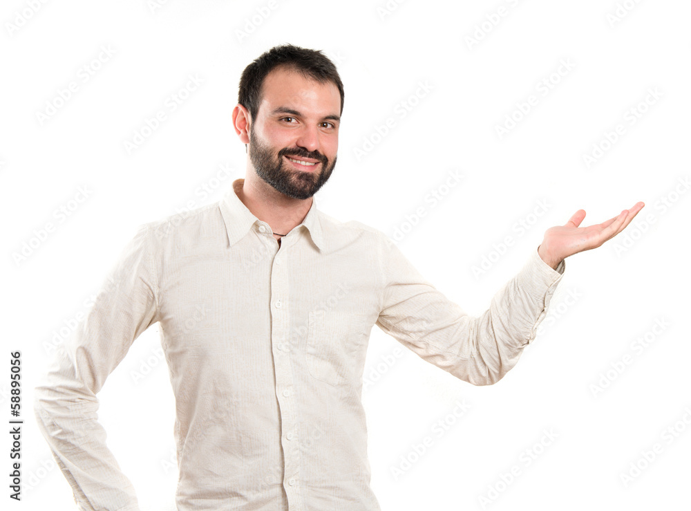 Man showing something over isolated white background Man showing something over isolated white background