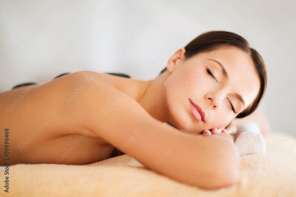 beautiful woman in spa salon with hot stones beautiful woman in spa salon with hot stones