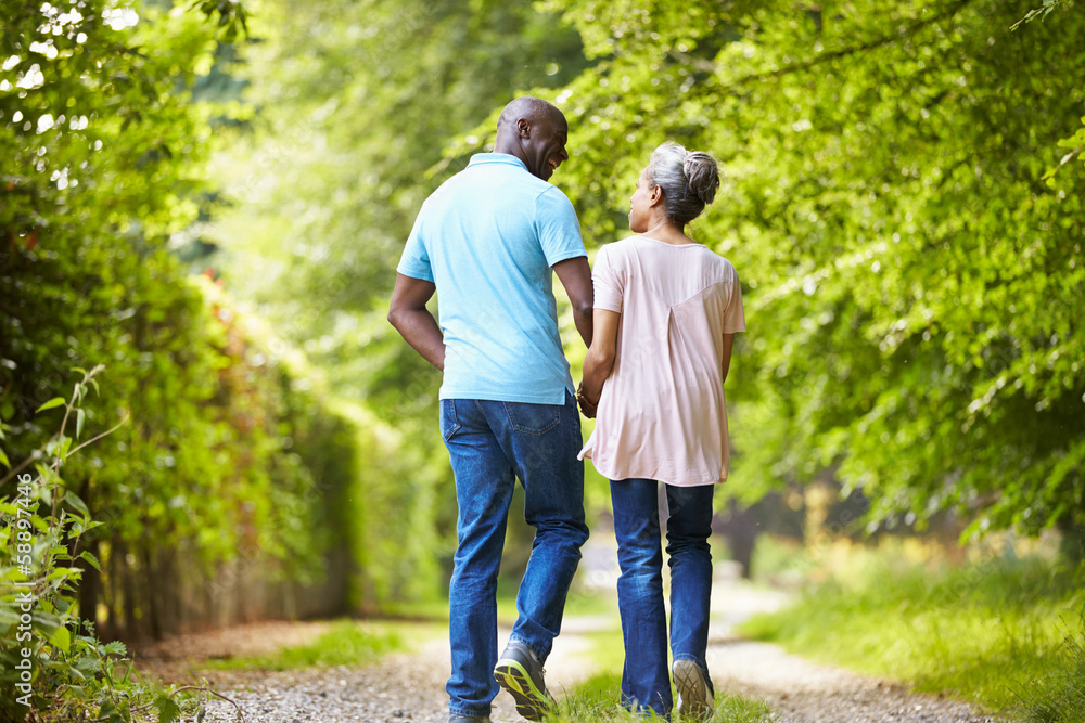 Mature African American Couple Walking In Countryside Mature African American Couple Walking In Countryside
