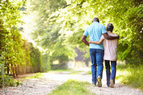 Mature African American Couple Walking In Countryside