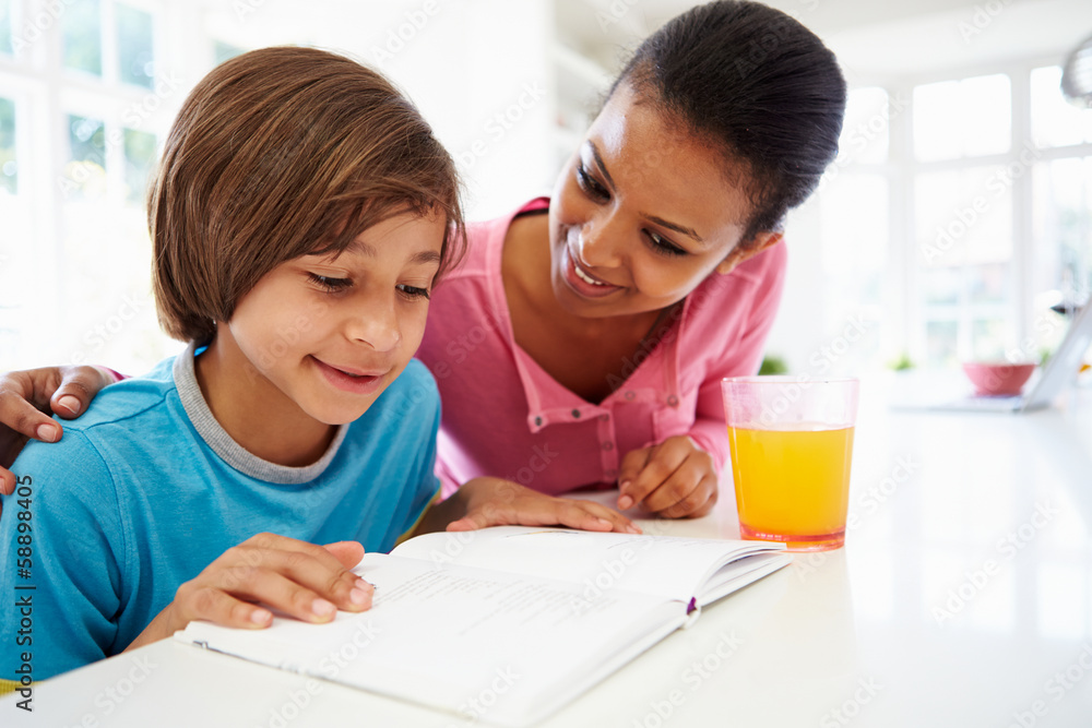 Mother Helping Son With Homework In Kitchen Mother Helping Son With Homework In Kitchen