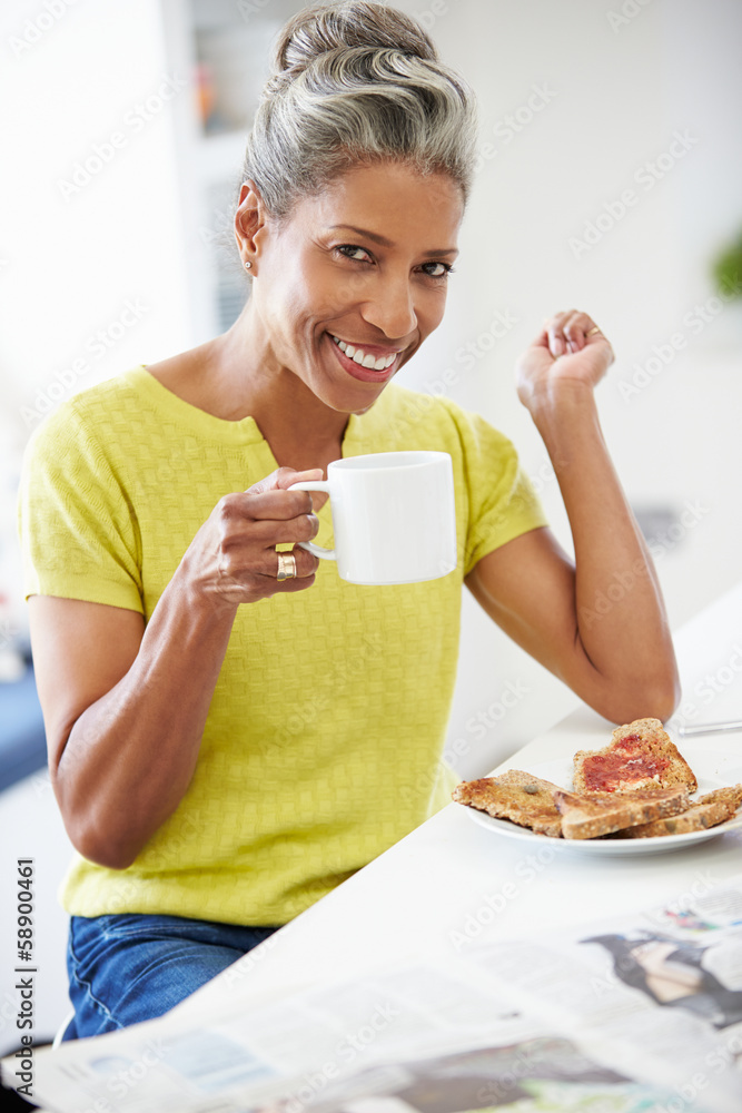 Mature Woman Eating Breakfast And Reading Newspaper Mature Woman Eating Breakfast And Reading Newspaper
