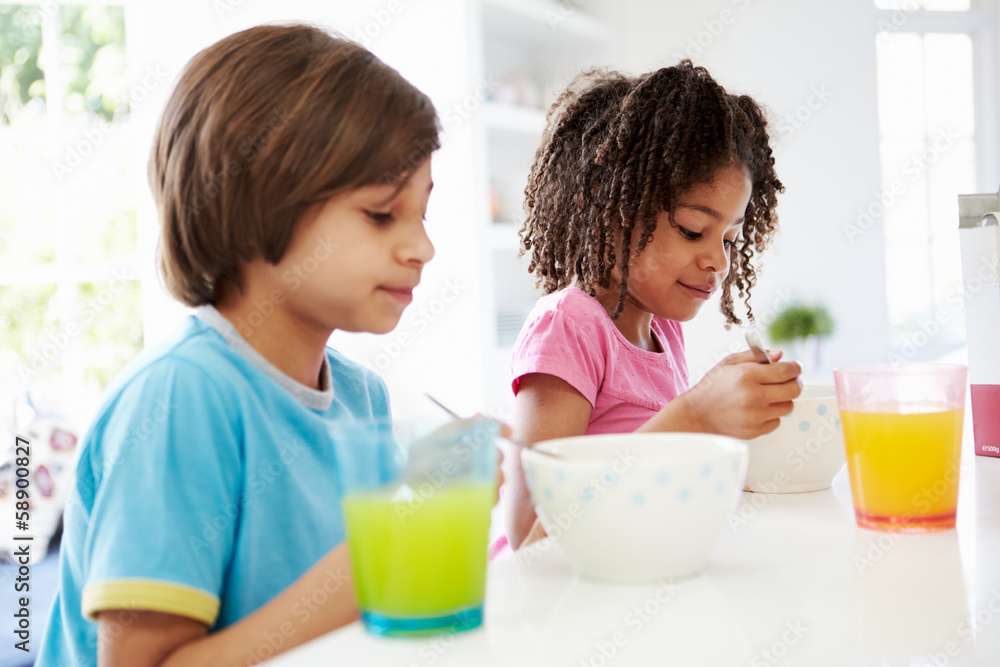 Two Children Having Breakfast In Kitchen Together Two Children Having Breakfast In Kitchen Together
