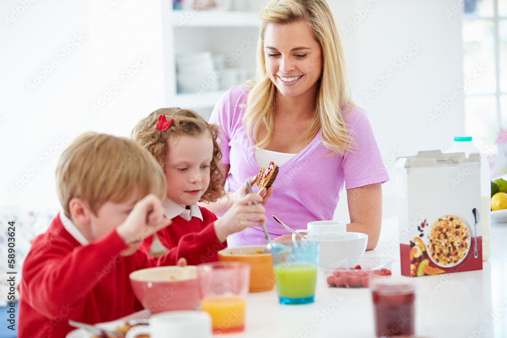 Mother And Children Having Breakfast In Kitchen Together Mother And Children Having Breakfast In Kitchen Together