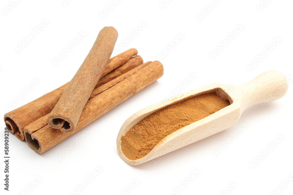 Powdery and stack of cinnamon sticks on white background Powdery and stack of cinnamon sticks on white background