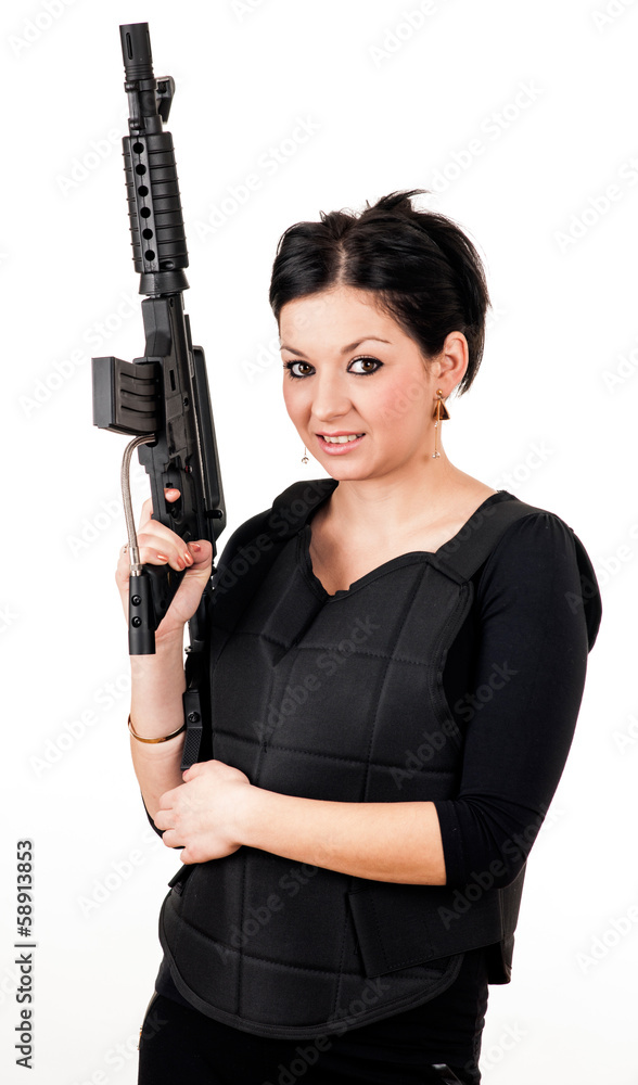 Young girl with black gun and paintball equipment Young girl with black gun and paintball equipment