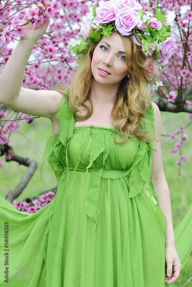 Beautiful girl in a flowered garden peach Beautiful girl in a flowered garden peach