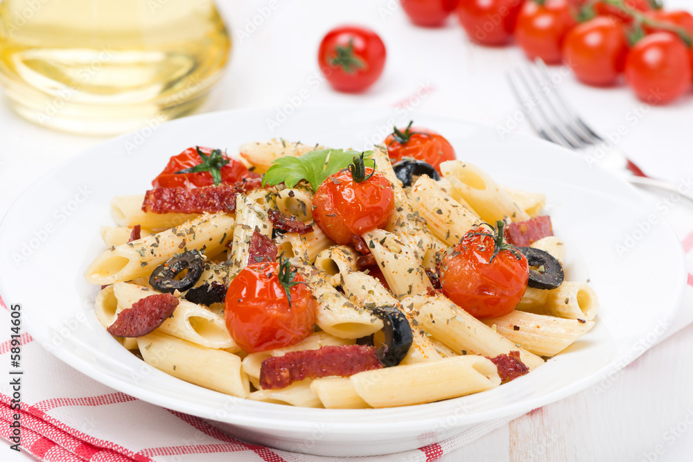 pasta with sausage, cherry tomatoes and olives on the plate pasta with sausage, cherry tomatoes and olives on the plate