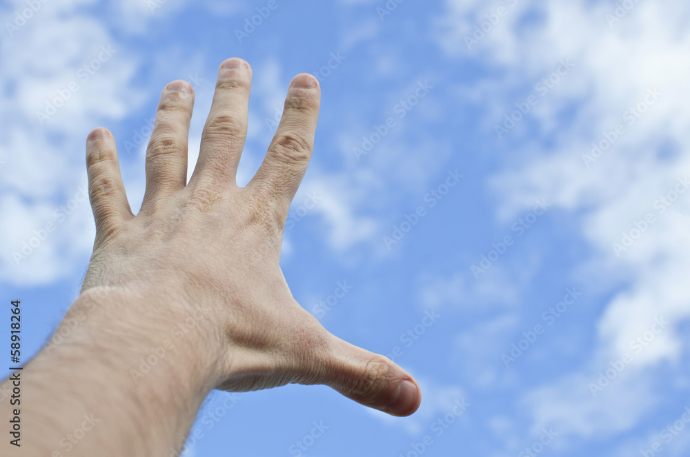 hand stretched to the blue cloudy sky hand stretched to the blue cloudy sky