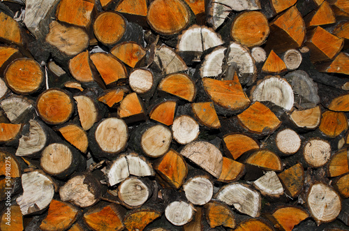 background of stacked chopped wood prepared for winter