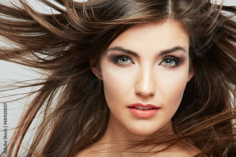 Woman face with hair motion on white background Woman face with hair motion on white background