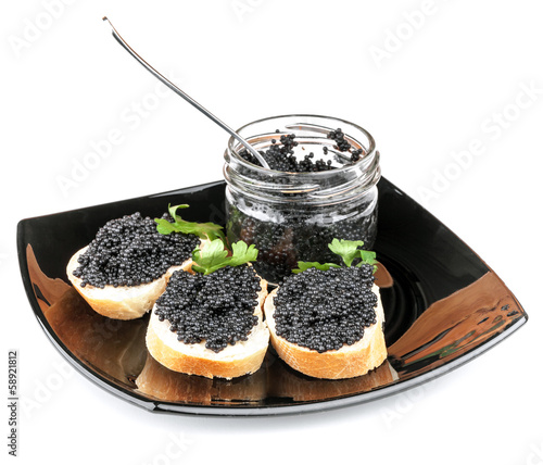 Sandwiches with black caviar on plate isolated