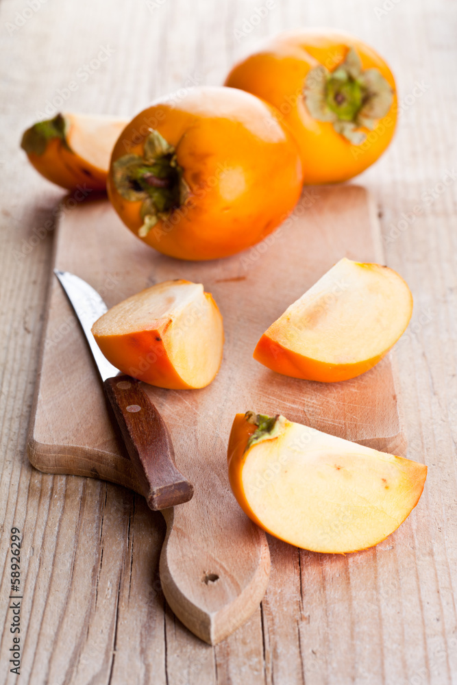 ripe persimmons and knife