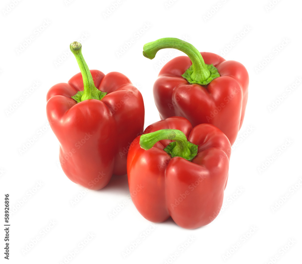 Three whole red ripe bell peppers isolated close up Three whole red ripe bell peppers isolated close up