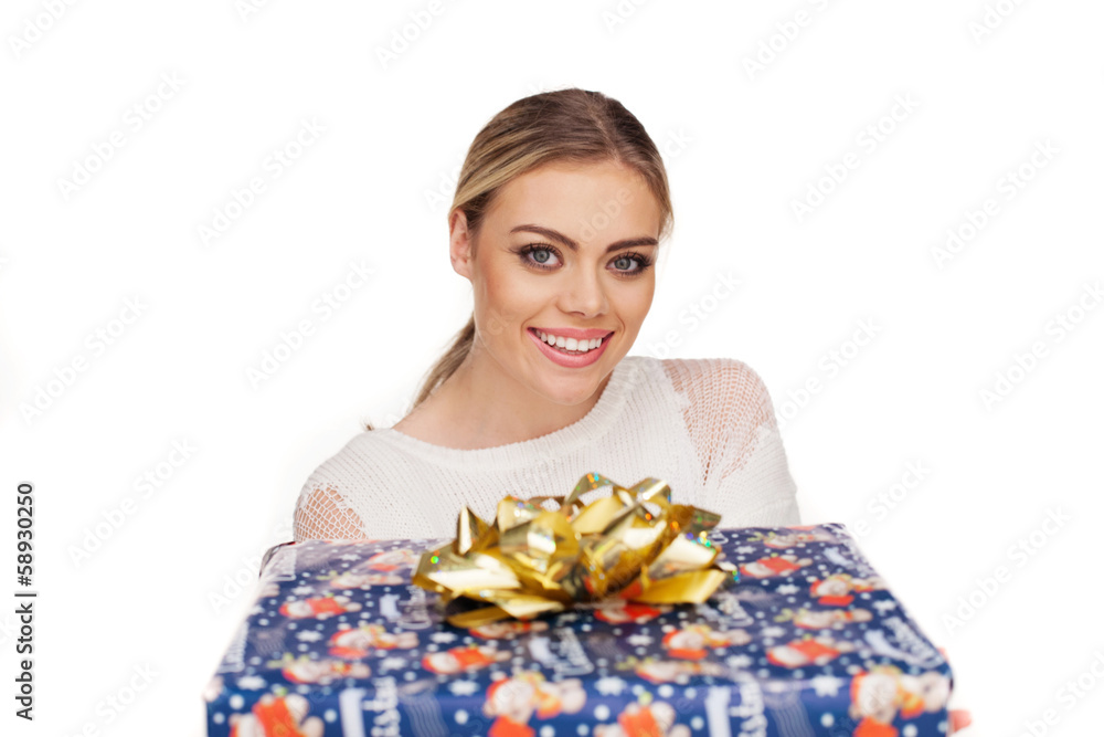woman holds a gift wrapped in christmas paper woman holds a gift wrapped in christmas paper