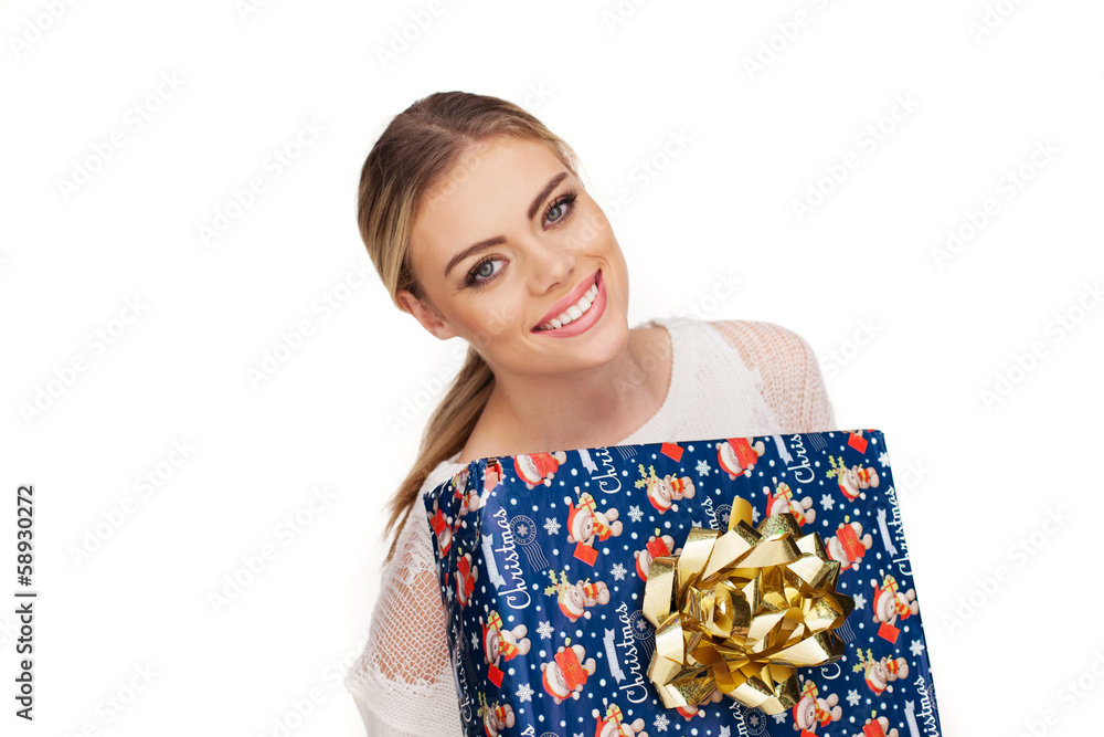 woman holds a gift wrapped in christmas paper woman holds a gift wrapped in christmas paper