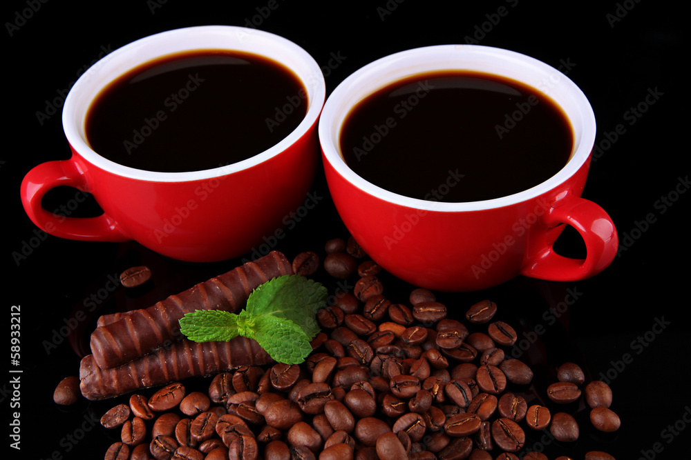 Red cups of strong coffee with coffee beans and chocolate bars Red cups of strong coffee with coffee beans and chocolate bars