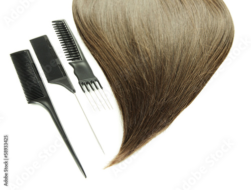 Shiny brown hair with combs isolated on white