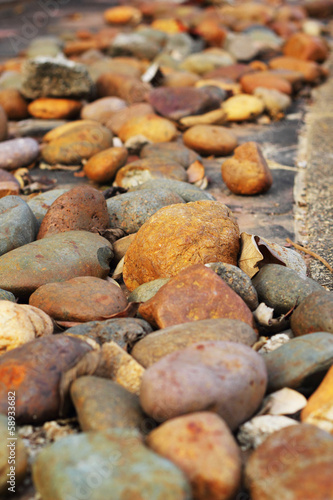 Photography Brown stones laid on a cement floor.