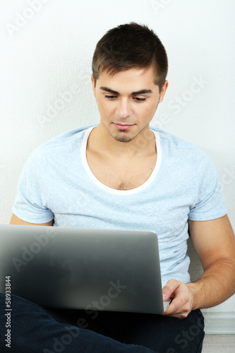 Guy sitting on floor in room