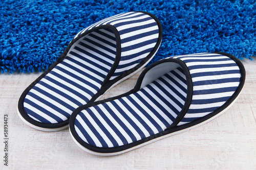 Striped slippers on floor background