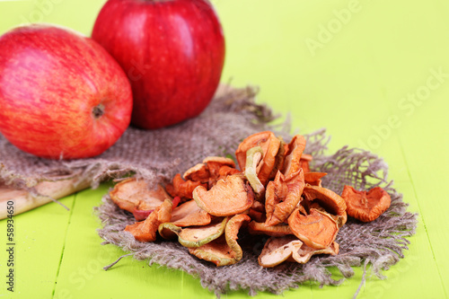 Dried apples  on cutting board   on color wooden background