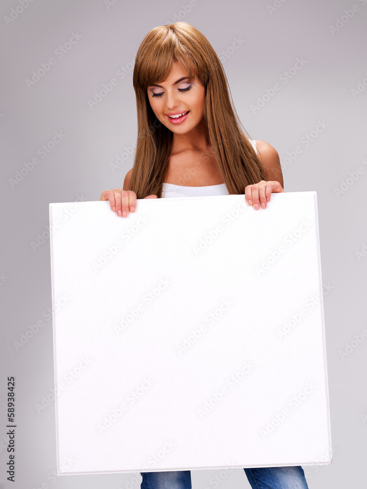 Young smiling woman holds white big banner Young smiling woman holds white big banner
