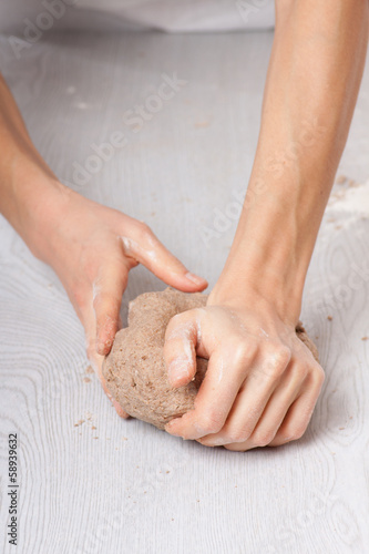 hands knead rye dough