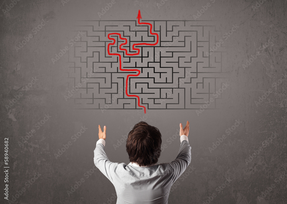 Business man looking at a maze and the way out Business man looking at a maze and the way out