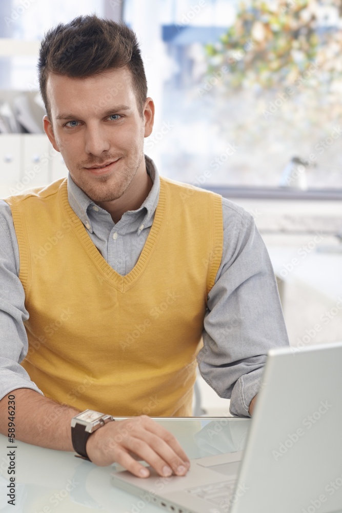 Office portrait of young businessman smiling Office portrait of young businessman smiling