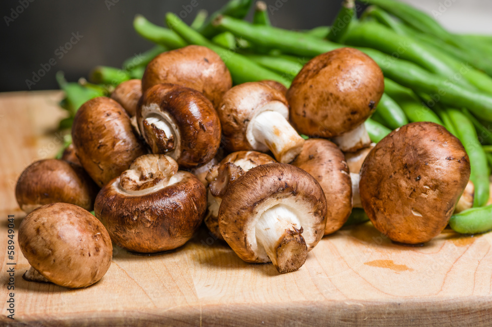 Mushrooms and green beans on a wooden board Mushrooms and green beans on a wooden board