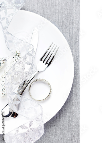 Elegant table setting place with festive decorations on white pl