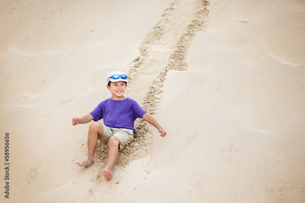 Boy rolled down the slope of snow-white dunes Boy rolled down the slope of snow-white dunes