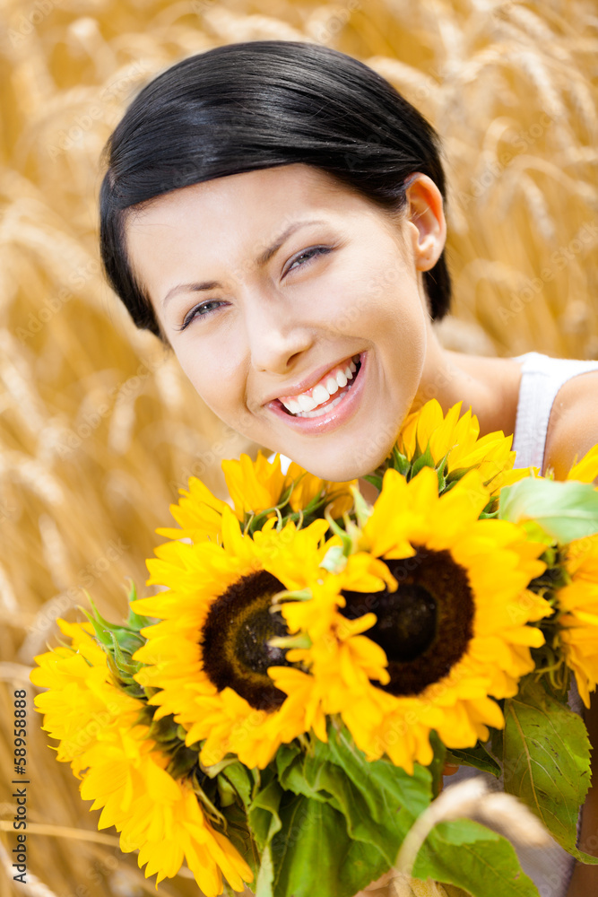 Close up of pretty lady with sunflowers in the rye field Close up of pretty lady with sunflowers in the rye field