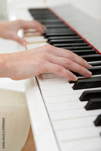 Close up of hands playing piano