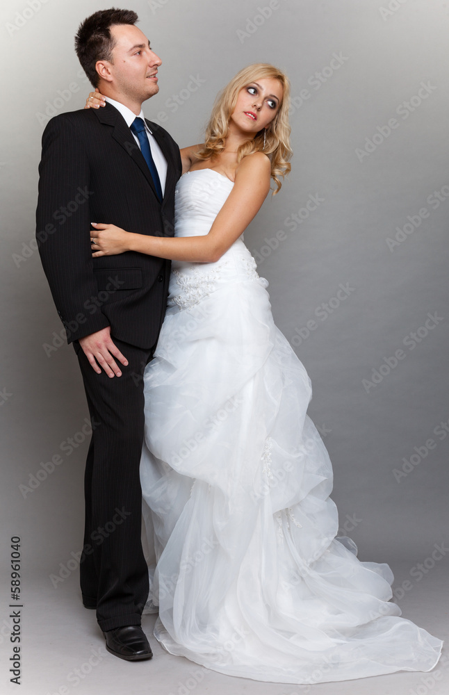 Happy married couple bride groom on gray background