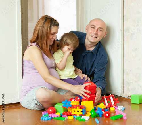 Happy parents and child in home